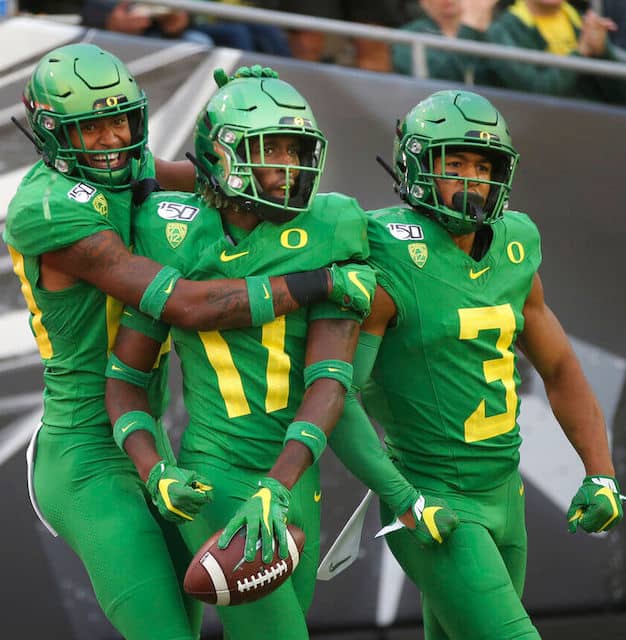 3 football players celebrating
